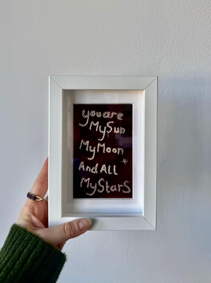 Framed hand-embroidered piece reading 'you are my sun, my moon and all my stars'