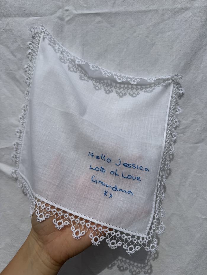 Lace-trimmed handkerchief embroidered with a handwritten message