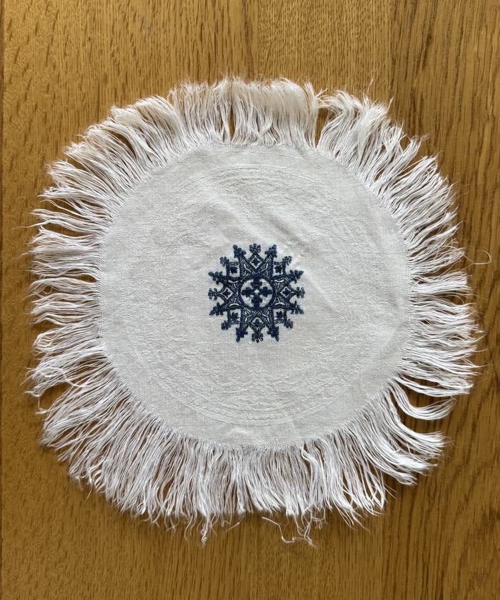Vintage fringed linen doily, embroidered motif